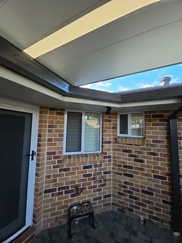 New continuous guttering along a brick home corner