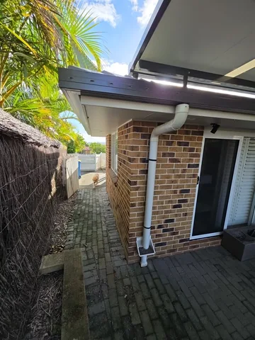 New downpipe on a brick home courtyard