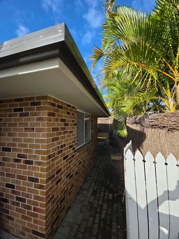 New grey guttering on a brick home