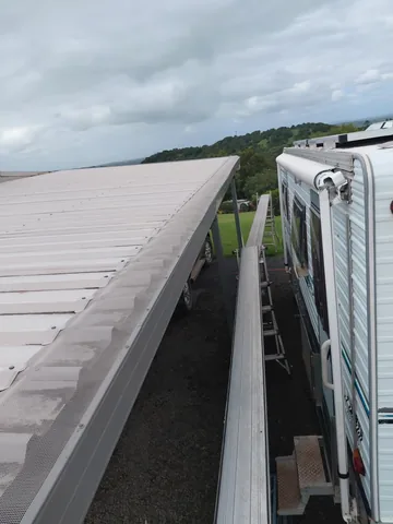 Gutter guard mesh running the length of a metal roofline