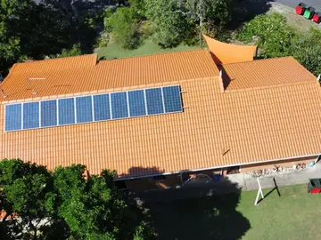 Aerial view of a restored tiled roof with solar panels on a Northern Rivers home